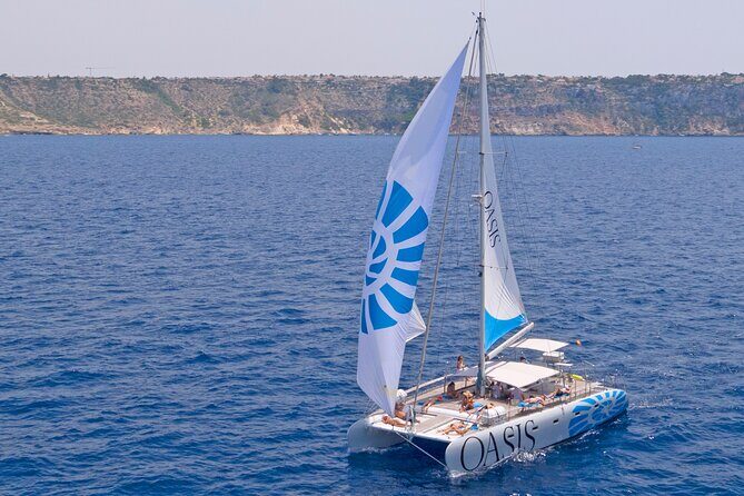 Catamaran sailing at sunset with tapas Palma de Mallorca - Returning through Palma: passing the Cathedral and sailing into the port light