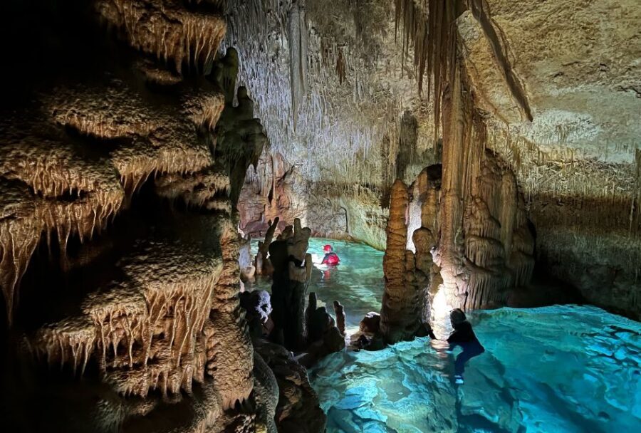 Mallorca: Aquatic Cave Exploration Guided Tour - Entering the cave lakes: stalactites, stalagmites, and real cave stories