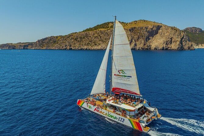 Mallorca Catamaran Cruise with Scenic Views and BBQ Lunch - Aucanada Beach and lighthouse views: cooling off plus photo time