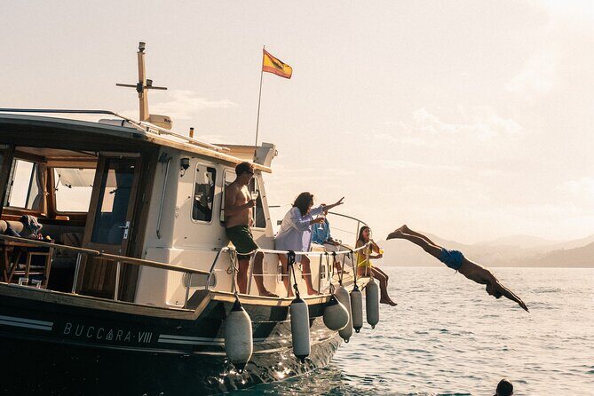 Traditional Boat Sailing Tour from Port of Palma - A small wooden Menorcan boat leaves Palma’s port